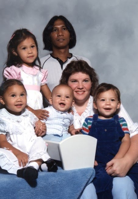 Four young children with their parents