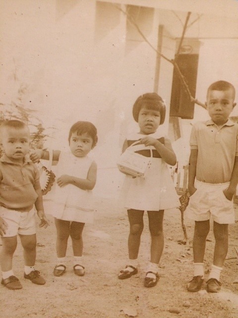 Black and white photo showing four young children