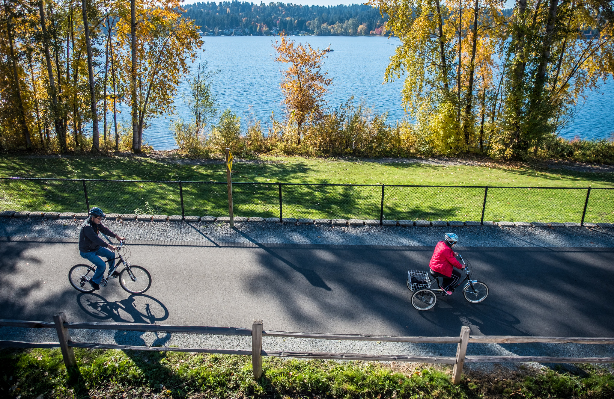 A view of a paved trail next to a lake