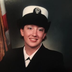 A woman wearing a military uniform smiling.