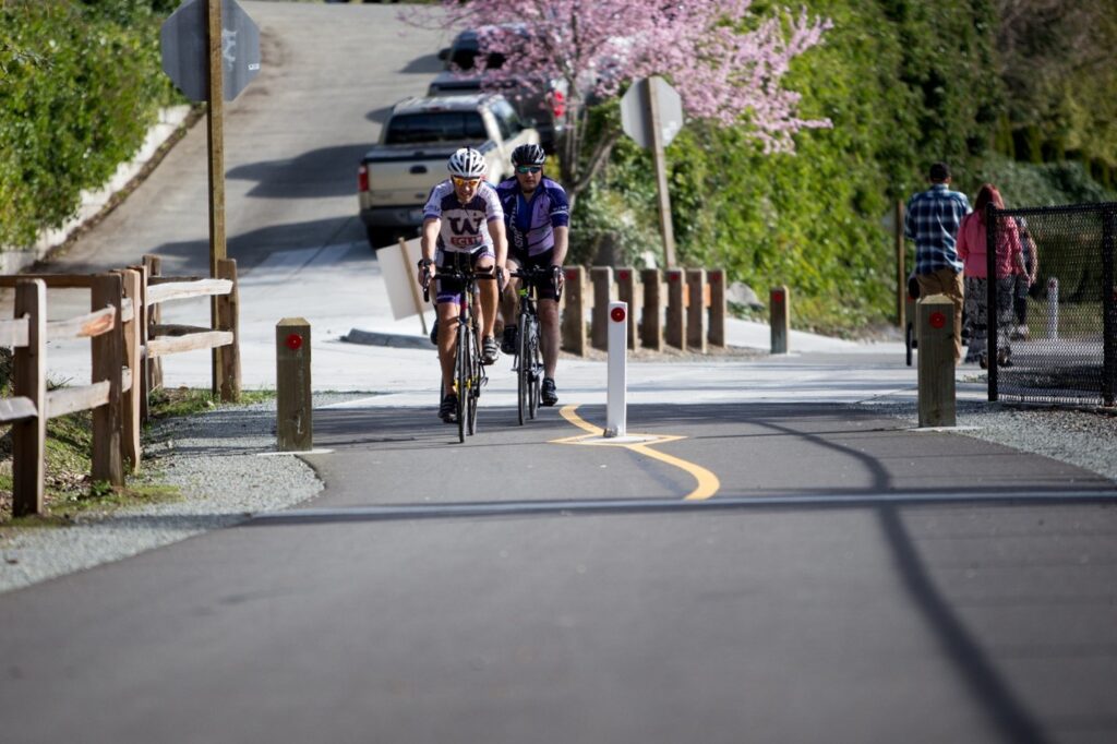 People riding bikes on a paved trail