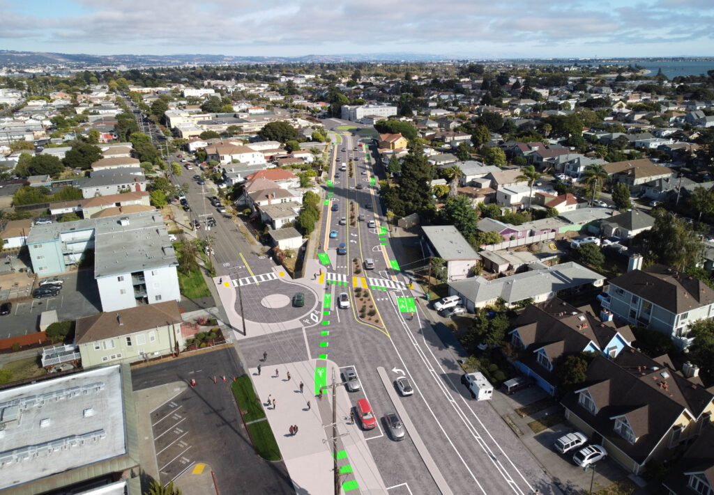 A rendering showing a bird's eye view of two streets diverging with a roundabout and green markings
