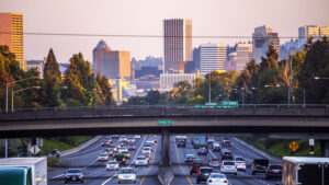 An aerial view of a highway leading into a city