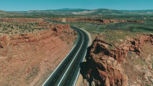 An aerial view of a highway winding through a rocky canyon.