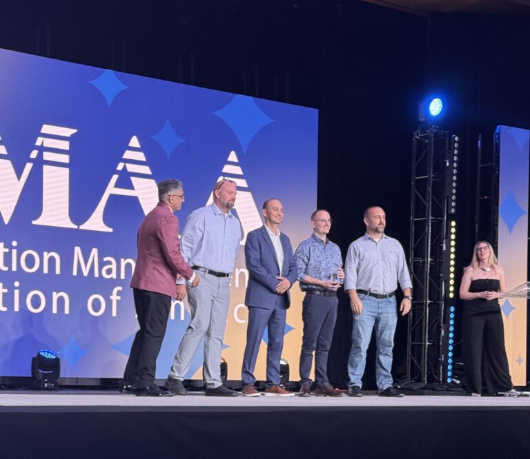 A group of people stands on a stage to accept an award