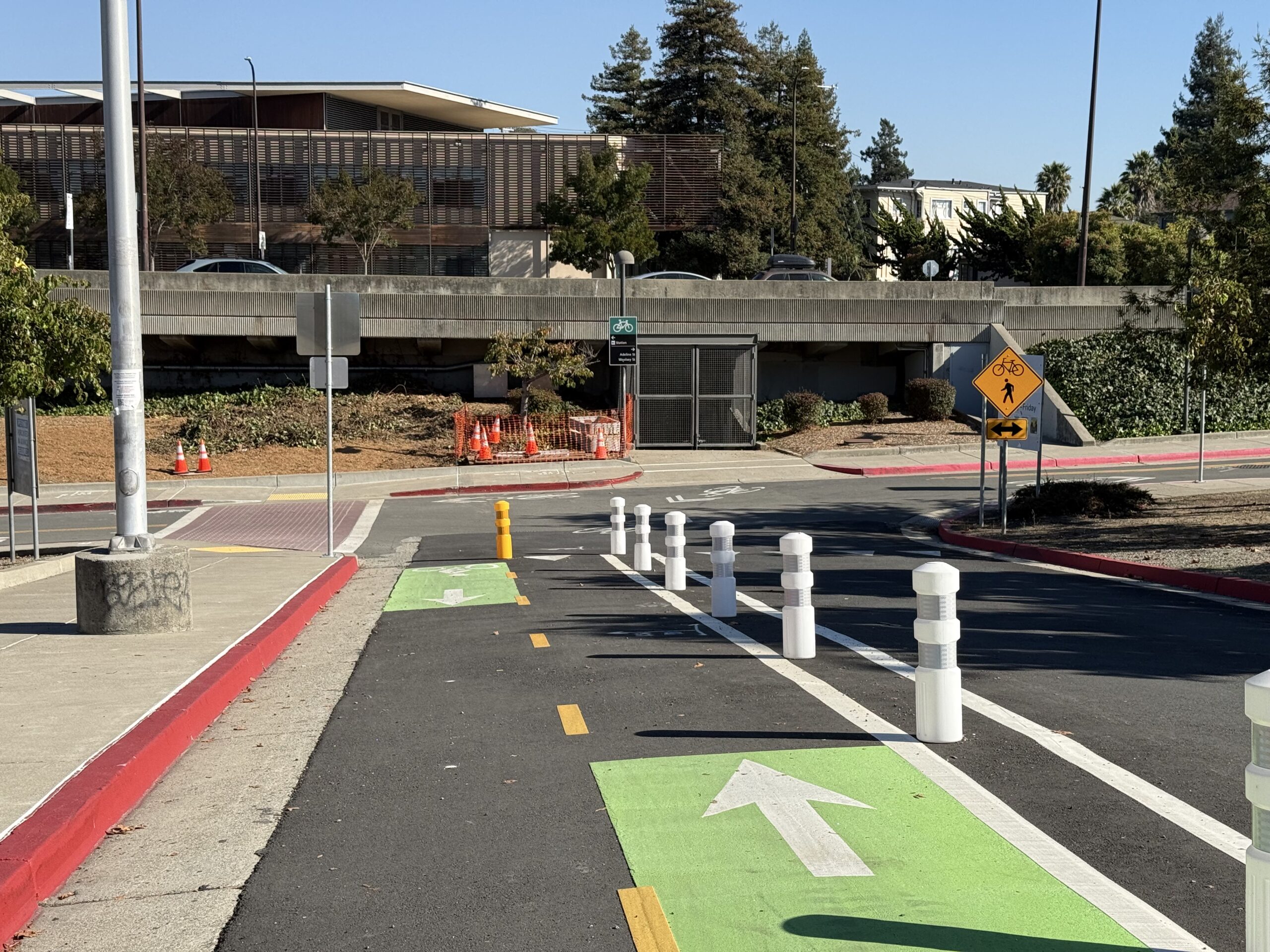 A separated bike lane marked with green and white arrows