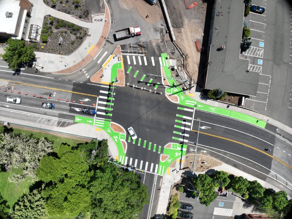 An aerial view of an intersection with green striping