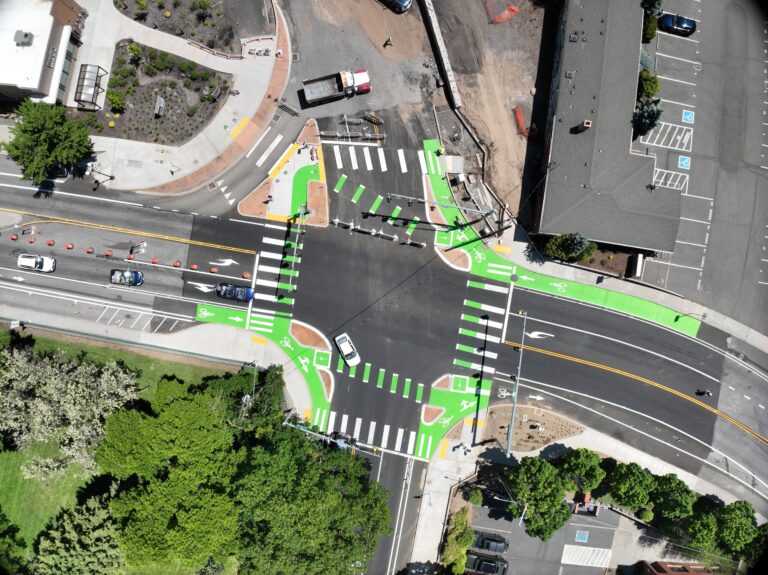 An aerial view of an intersection with green striping