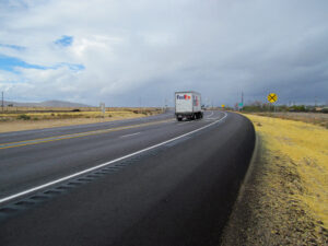 A truck drives along a highway