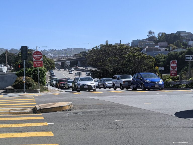 An intersection with cars exiting a freeway
