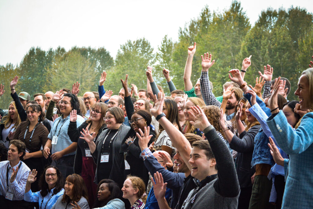 People pose for a photo with their hands up