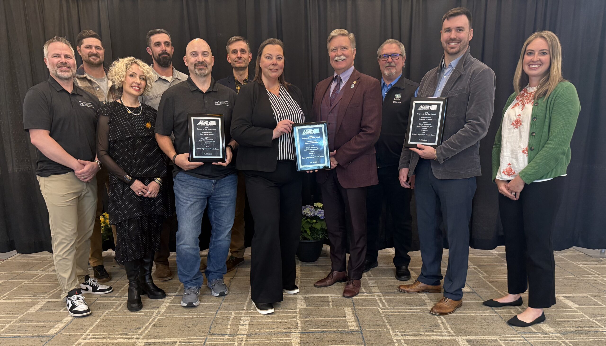 A group of people holding award plaques